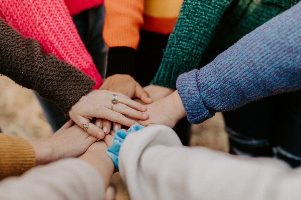 Hands stacked together in a supportive group