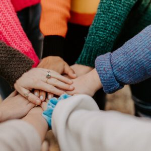Hands stacked together in a supportive group