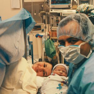 Parent and newborn in theatre after a positive caesarean