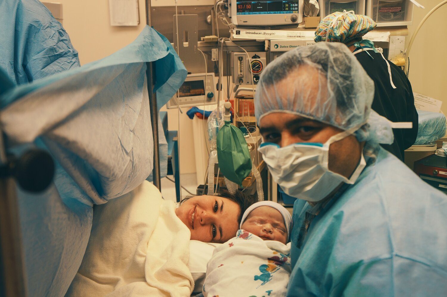 Parent and newborn in theatre after a positive caesarean